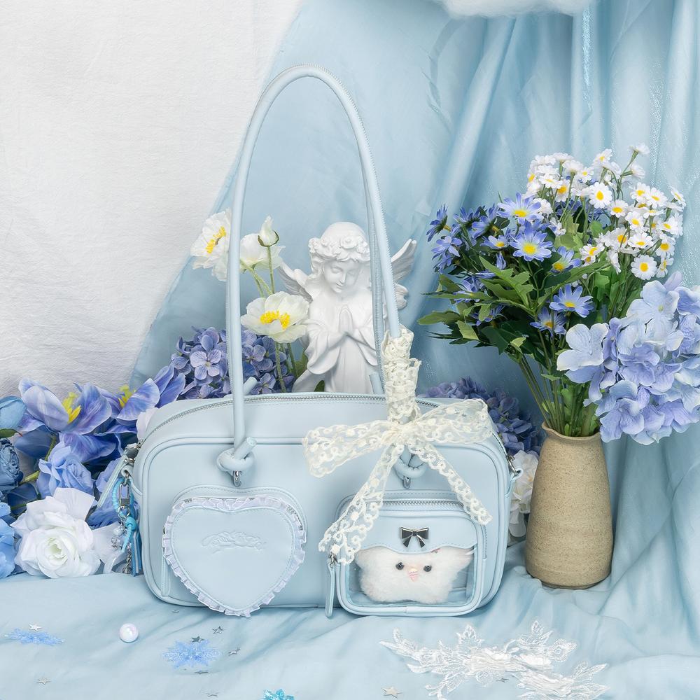 Woman holding a stylish cartoon handbag with a <a href='https://www.thejunco.com/product/【blue-deer】handbag-fairy-style-gentle-girl-tote-anime-ita-bag/'>blue deer design</a>, complementing a chic outfit.”/></figure>

<h2 id=